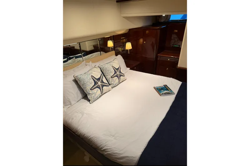 Slide: The Image of Luxurious bedroom interior of 2005 Neptunus 62 Flybridge yacht with starfish-themed pillows. - 82