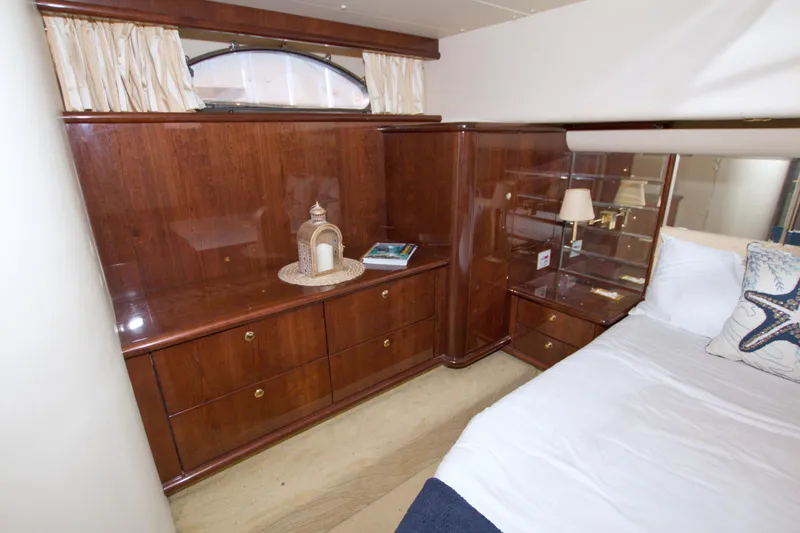 Slide: The Image of Luxurious 2005 Neptunus 62 Flybridge yacht bedroom with elegant wood cabinetry and cozy bedding. - 84