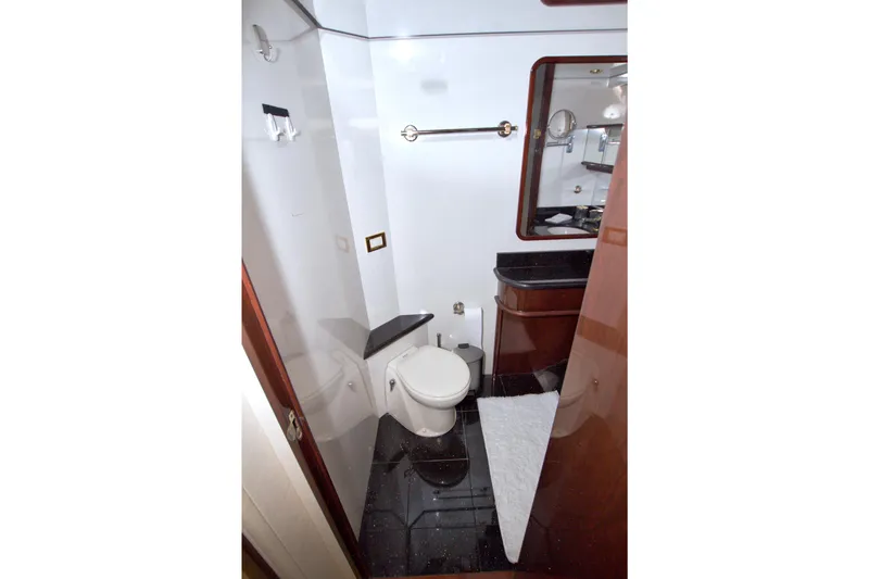 Slide: The Image of Luxurious bathroom in 2005 Neptunus 62 Flybridge yacht with elegant fixtures and dark flooring. - 87
