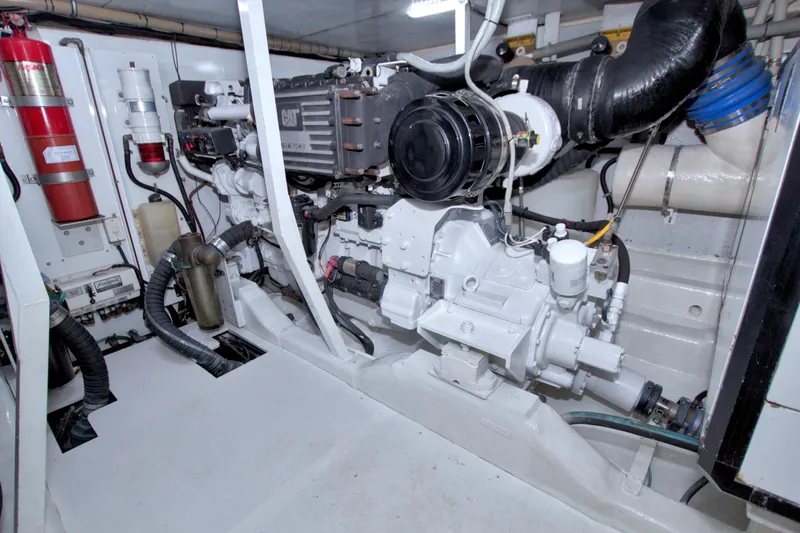 Slide: The Image of Engine room of 2005 Neptunus 62 Flybridge yacht, featuring CAT machinery and fire extinguisher. - 93