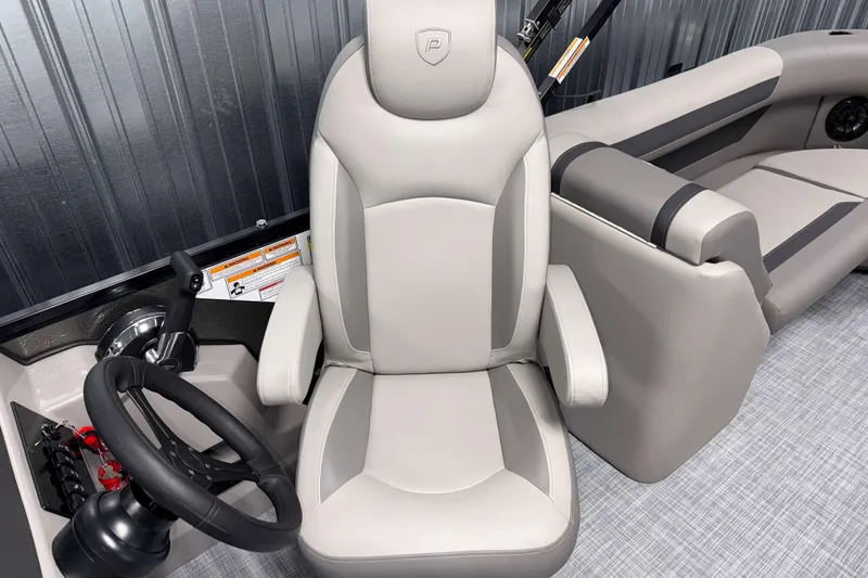 Slide: The Image of 2026 Premier 220 Sunscape RF boat interior with steering wheel and plush seating. - 12