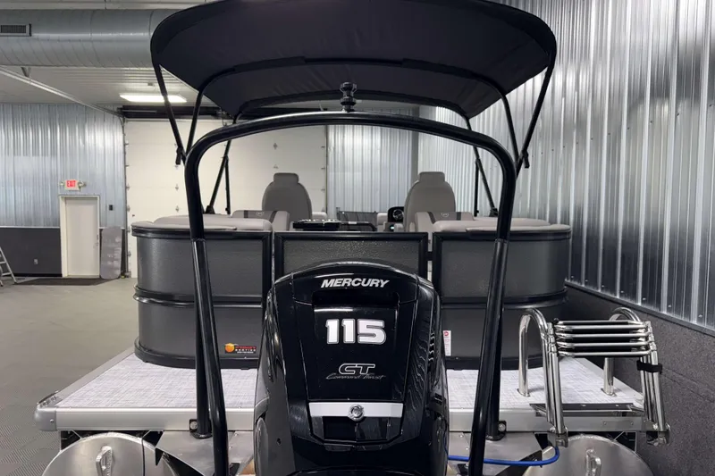 Slide: The Image of 2026 Premier 220 Sunscape RF boat with Mercury 115 engine in a metal-walled showroom. - 5