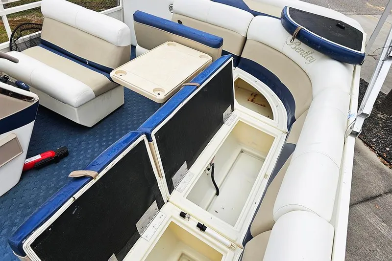 Slide: The Image of 2004 Bentley Pontoons 240 Fish interior with seating, storage compartments, and table. - 12