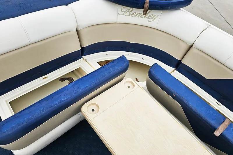 Slide: The Image of 2004 Bentley Pontoons 240 Fish interior with blue and beige seating and storage compartments. - 13
