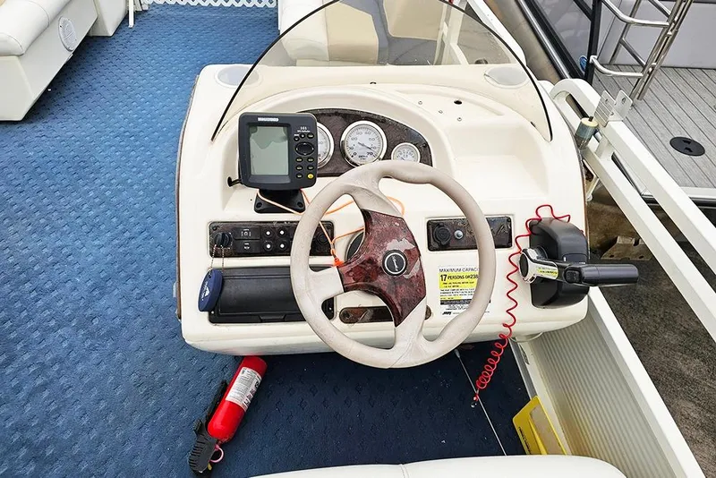 Slide: The Image of 2004 Bentley Pontoons 240 Fish dashboard with steering wheel and control panel. - 20
