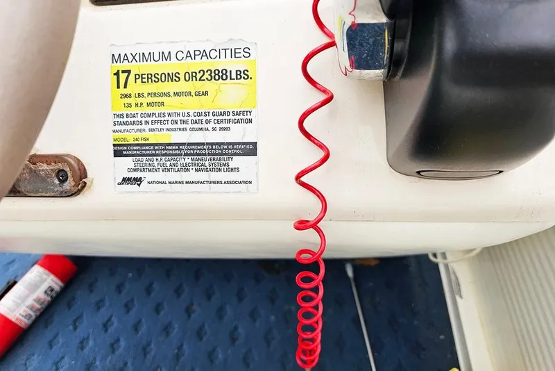 Slide: The Image of 2004 Bentley Pontoons 240 Fish capacity label, 17 persons or 2388 lbs, safety compliance. - 21