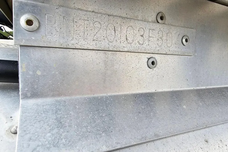 Slide: The Image of VIN plate on a 2004 Bentley Pontoons 240 Fish boat, showing identification number. - 22