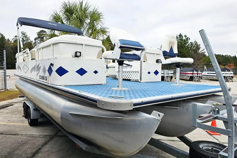 Slide: The Image of 2004 Bentley Pontoons 240 Fish boat on trailer, featuring blue and white design. - 3