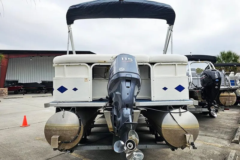 Slide: The Image of 2004 Bentley Pontoons 240 Fish with outboard motor in a marina setting. - 5