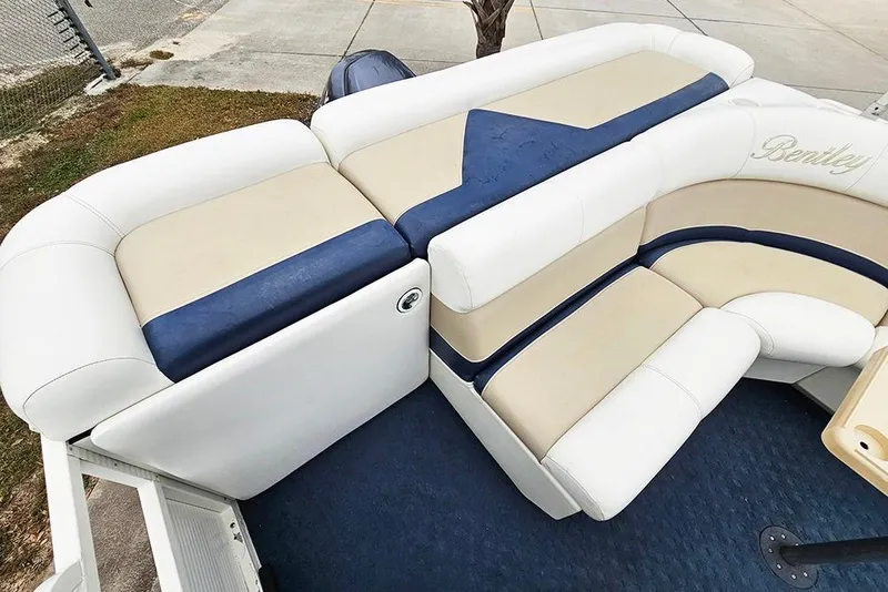 Slide: The Image of 2004 Bentley Pontoons 240 Fish boat interior with beige and blue seating. - 9