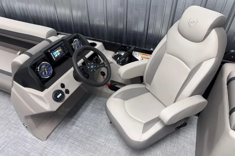 Slide: The Image of 2026 Premier 220 Sunscape RF Tritoon helm with modern dashboard and comfortable captain's chair. - 11