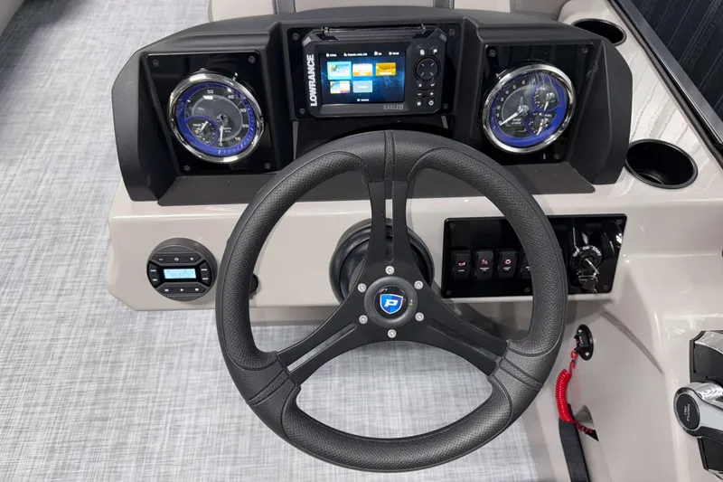 Slide: The Image of 2026 Premier 220 Sunscape RF Tritoon dashboard with steering wheel and navigation display. - 12