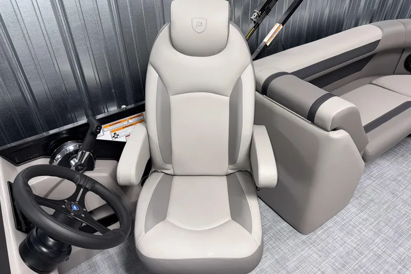 Slide: The Image of 2026 Premier 220 Sunscape RF Tritoon helm with luxurious seating and modern steering wheel. - 13