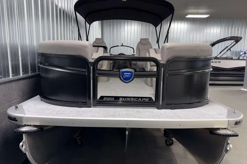 Slide: The Image of 2026 Premier 220 Sunscape RF Tritoon boat in showroom, front view. - 2