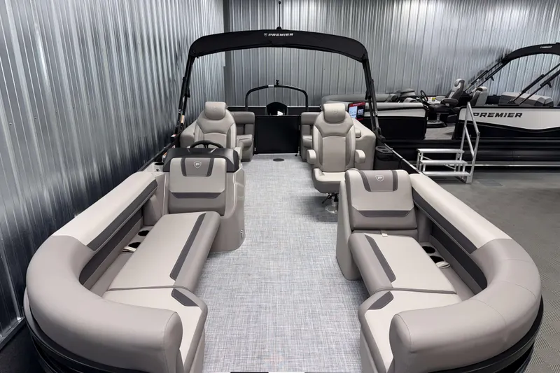 Slide: The Image of 2026 Premier 220 Sunscape RF Tritoon with luxurious seating in a showroom. - 7