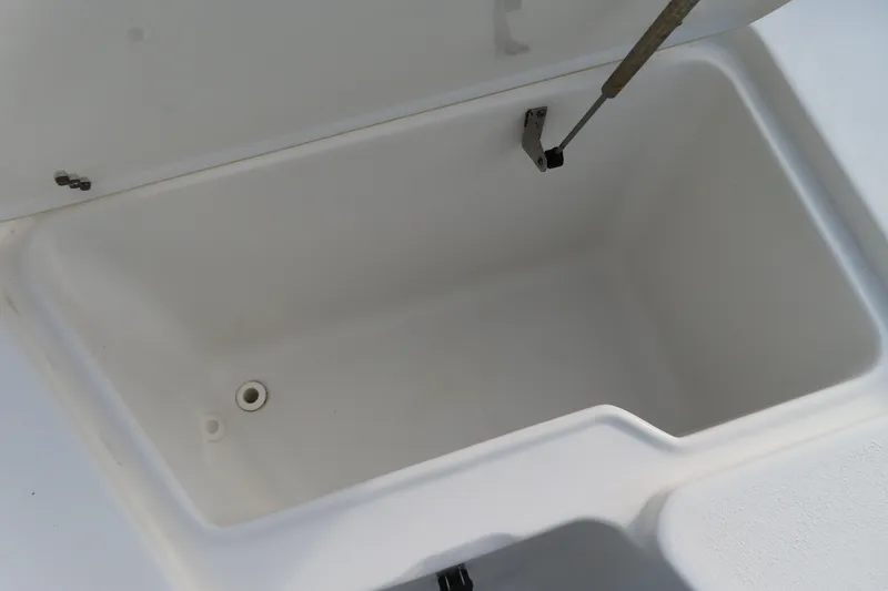 Slide: The Image of 2019 Sea Hunt Ultra 234 boat storage compartment, open and empty. - 10