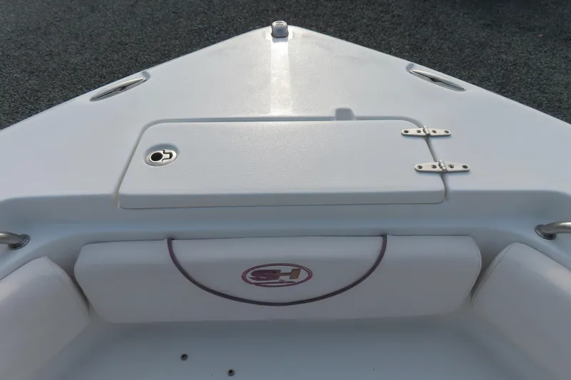Slide: The Image of 2019 Sea Hunt Ultra 234 boat bow with storage compartment and seating. - 12
