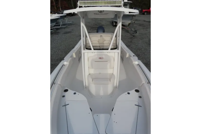 Slide: The Image of 2019 Sea Hunt Ultra 234 boat interior with seating and console. - 14