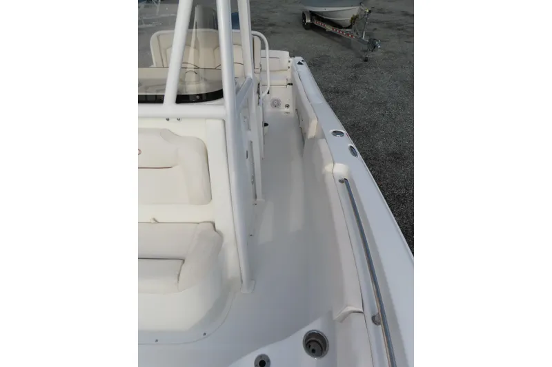 Slide: The Image of 2019 Sea Hunt Ultra 234 boat interior with seating and railing, parked on a trailer. - 16