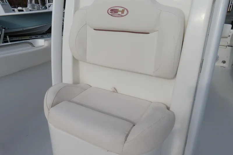 Slide: The Image of 2019 Sea Hunt Ultra 234 boat seat with white cushioned upholstery. - 17