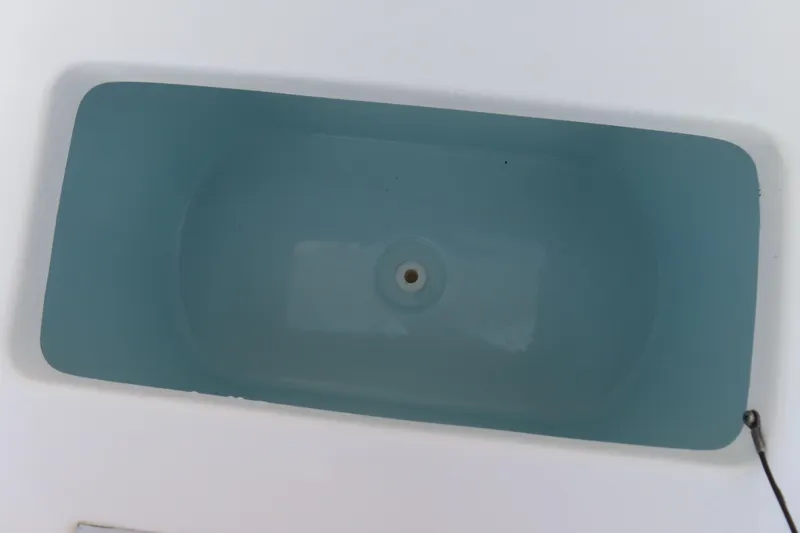 Slide: The Image of Livewell of 2019 Sea Hunt Ultra 234 boat, featuring a blue interior. - 18