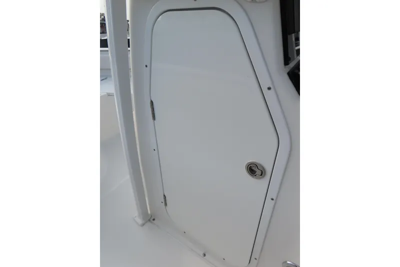 Slide: The Image of 2019 Sea Hunt Ultra 234 boat cabin door, white with a sleek design. - 19