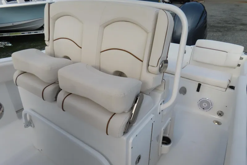 Slide: The Image of 2019 Sea Hunt Ultra 234 boat interior with cushioned seating and console. - 21