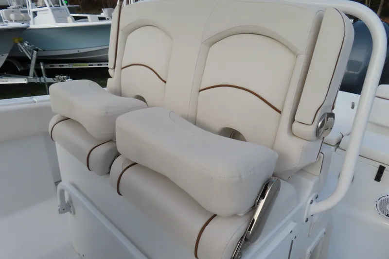 Slide: The Image of 2019 Sea Hunt Ultra 234 boat seating with cushioned backrests and armrests. - 22