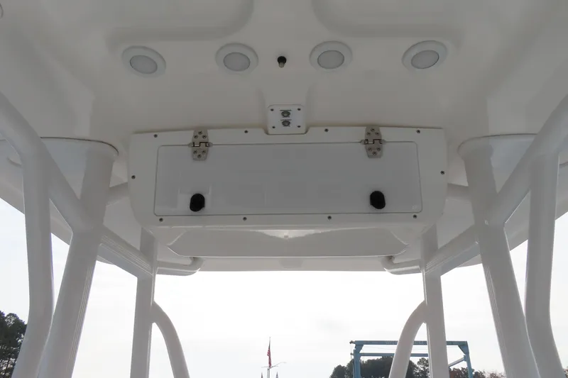 Slide: The Image of 2019 Sea Hunt Ultra 234 boat interior ceiling with storage compartment and lighting. - 27