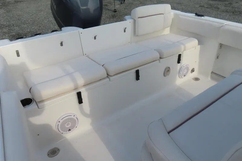 Slide: The Image of 2019 Sea Hunt Ultra 234 boat interior with white cushioned seating and speakers. - 29