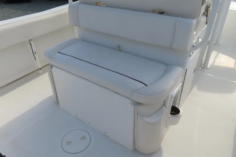 Slide: The Image of 2019 Sea Hunt Ultra 234 boat interior with white cushioned seating. - 30