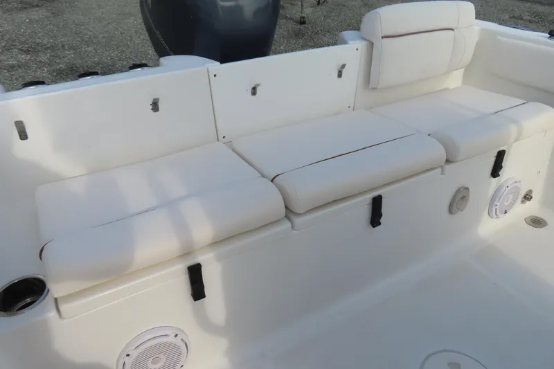 Slide: The Image of 2019 Sea Hunt Ultra 234 boat interior with cushioned seating and speakers. - 33