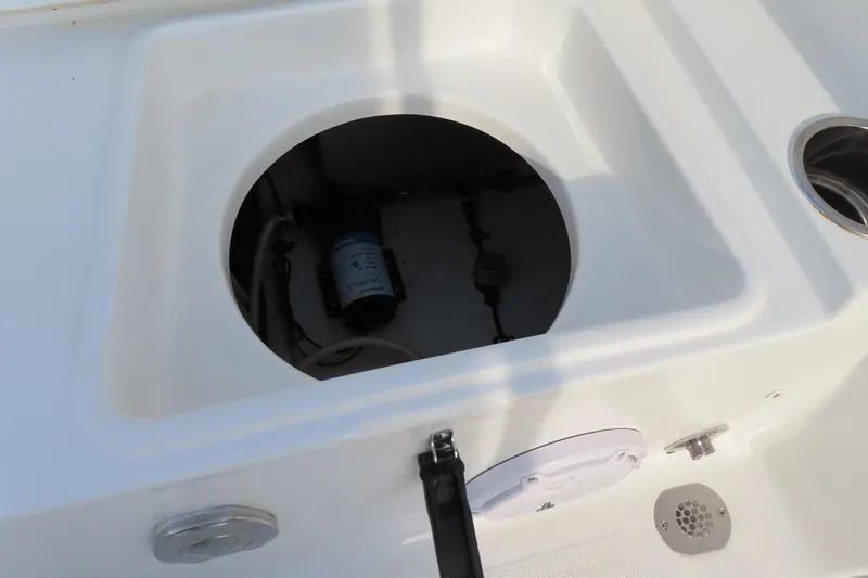 Slide: The Image of 2019 Sea Hunt Ultra 234 boat compartment with pump and drainage system. - 38