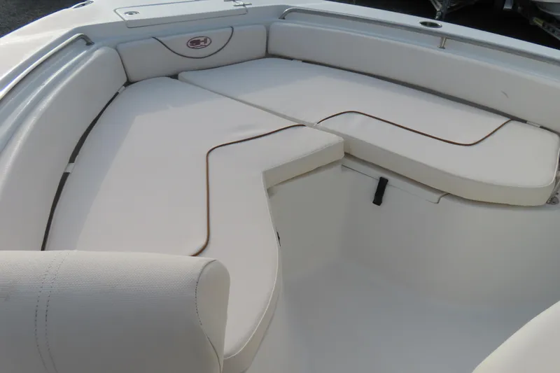Slide: The Image of 2019 Sea Hunt Ultra 234 boat with cushioned seating area. - 7