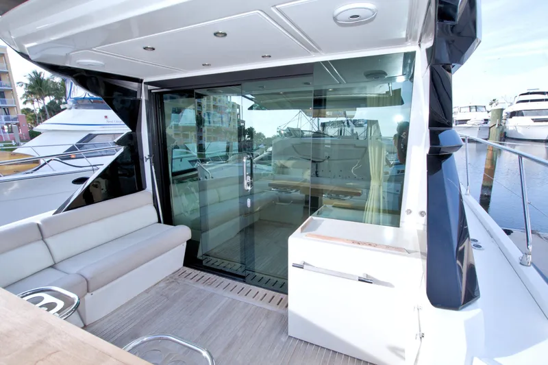 Slide: The Image of 2019 Beneteau Gran Turismo 50 yacht with sleek deck and glass doors in marina setting. - 15