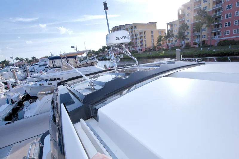 Slide: The Image of 2019 Beneteau Gran Turismo 50 yacht docked at marina with modern buildings in background. - 16