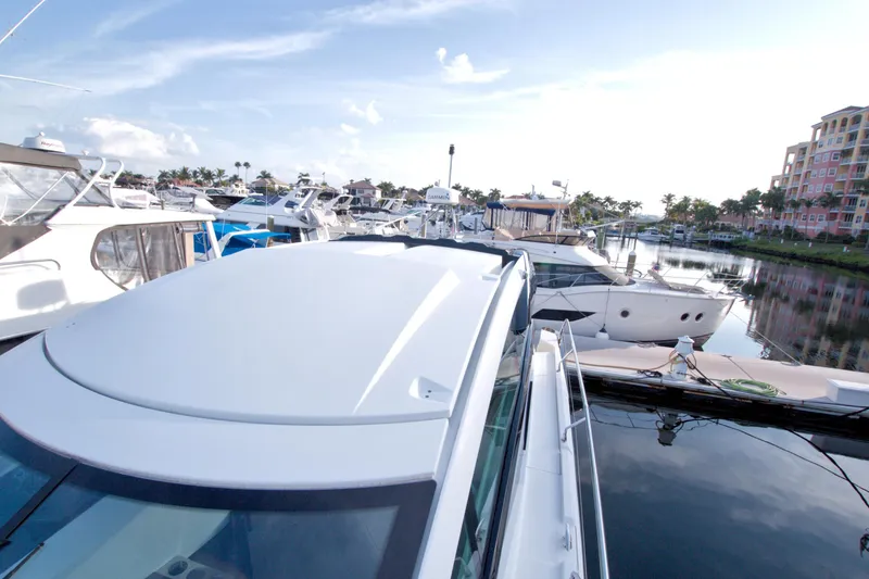 Slide: The Image of 2019 Beneteau Gran Turismo 50 yacht docked in a marina, surrounded by other boats. - 25