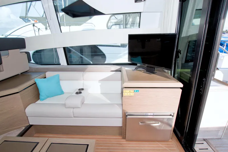 Slide: The Image of Interior of 2019 Beneteau Gran Turismo 50 yacht with white seating and TV. - 34
