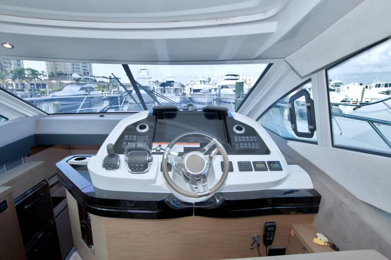Slide: The Image of Interior helm of 2019 Beneteau Gran Turismo 50 yacht, featuring modern controls and steering. - 38