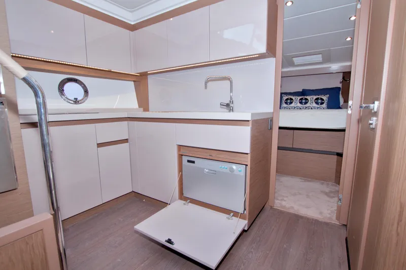 Slide: The Image of 2019 Beneteau Gran Turismo 50 yacht interior with modern kitchen and cozy bedroom. - 42