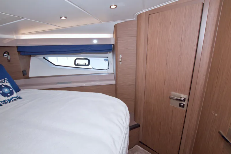 Slide: The Image of Luxurious cabin interior of 2019 Beneteau Gran Turismo 50 yacht with wood finish and cozy bedding. - 47