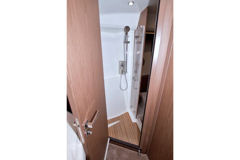Slide: The Image of 2019 Beneteau Gran Turismo 50 yacht shower with modern fixtures and wooden accents. - 49