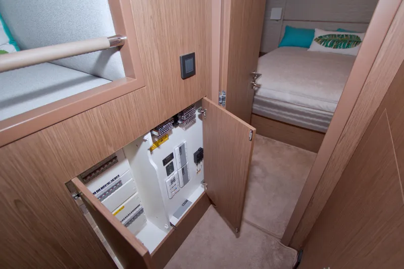 Slide: The Image of 2019 Beneteau Gran Turismo 50 interior with open electrical panel and cozy bedroom. - 57
