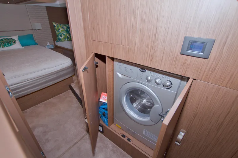 Slide: The Image of 2019 Beneteau Gran Turismo 50 interior with washing machine and cozy bedroom. - 58