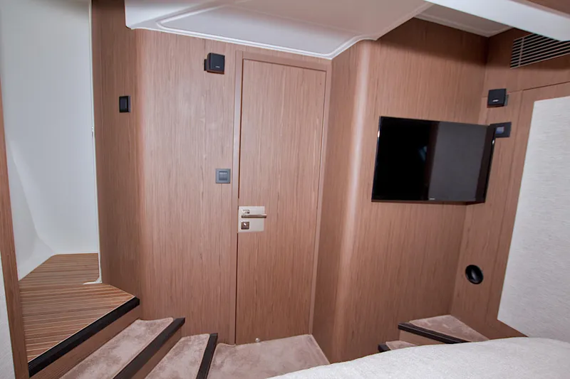 Slide: The Image of Interior of 2019 Beneteau Gran Turismo 50 yacht with wooden paneling and wall-mounted TV. - 61