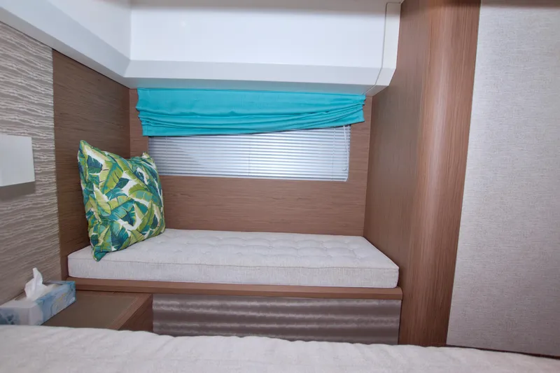 Slide: The Image of 2019 Beneteau Gran Turismo 50 interior with cushioned seating and tropical pillow. - 65