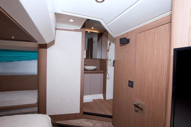 Slide: The Image of 2019 Beneteau Gran Turismo 50 interior with modern wood finish and compact bathroom. - 66