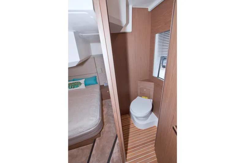 Slide: The Image of 2019 Beneteau Gran Turismo 50 interior with bedroom and bathroom, featuring modern wood finishes. - 67