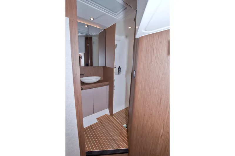 Slide: The Image of 2019 Beneteau Gran Turismo 50 bathroom with modern wood finish and vessel sink. - 68