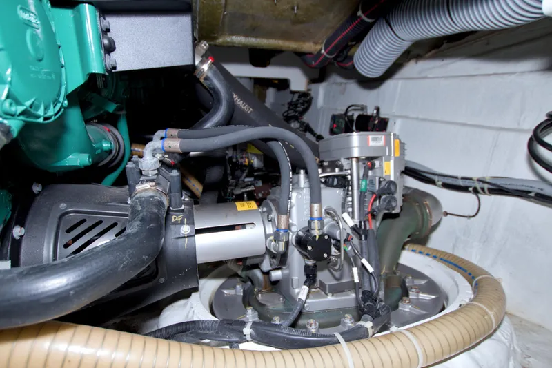 Slide: The Image of Engine room of 2019 Beneteau Gran Turismo 50 yacht, showcasing mechanical components and hoses. - 75